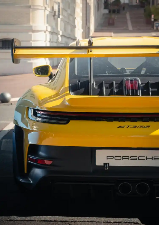 Yellow sports car from behind canvas painting in yellow, grey and black