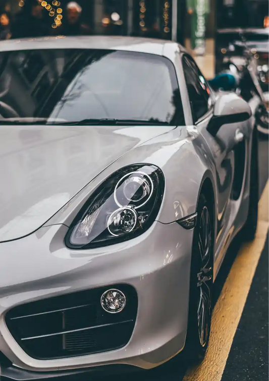 Grey sports car canvas painting, close-up on a city street in beige and yellow tones