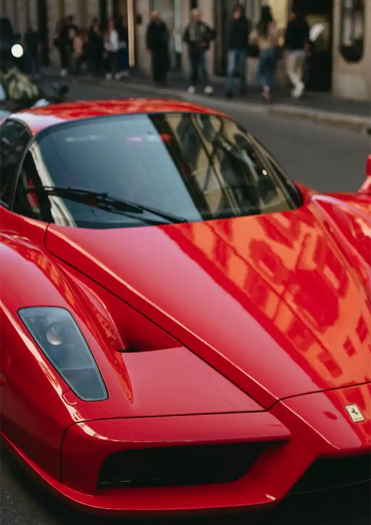 Red sports car canvas painting in close up on a city street