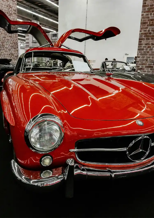 Red sports car canvas painting with open gullwing doors, classic style