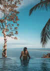 Woman in Infinity Pool with Palm Trees and Tropical Sea Horizon Canvas Print
