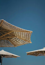 Braided Reed Parasols against Blue Sky Canvas Painting