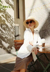Elegant Lady in White Outfit on Terrace with Sunglasses Painting