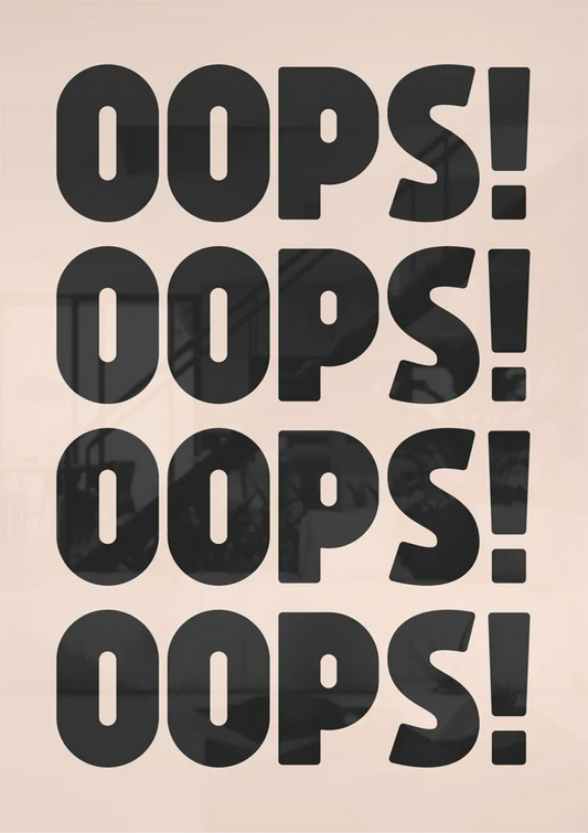 Oops text canvas painting on the wall above the sofa in the bedroom