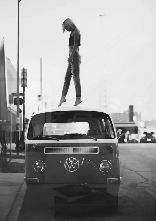Camper van with person on roof canvas painting on the wall above the bed in the bedroom
