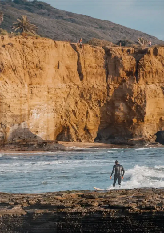 Surfer bij Gouden Kliffen Oceaan Golven Kustlandschap Canvas Schilderij
