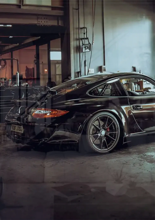 Black sports car canvas painting on the wall above the bed in the bedroom