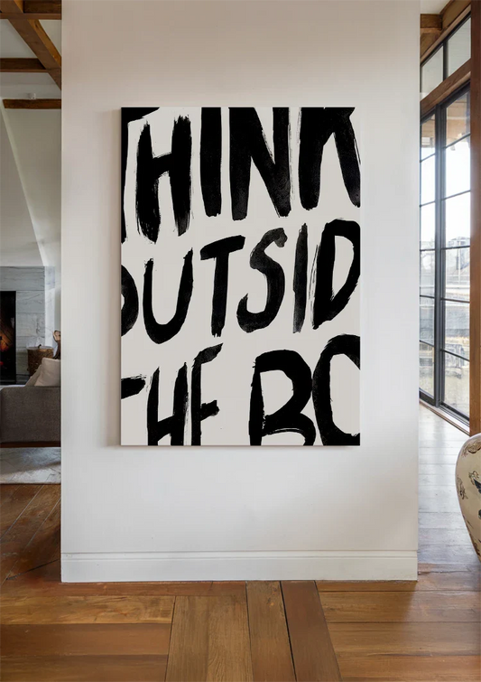 Think outside the box text canvas painting on the wall by the front door in the hallway