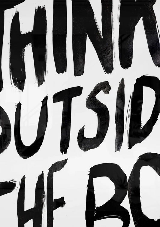 Think outside the box text canvas painting on the wall above the bed in the bedroom
